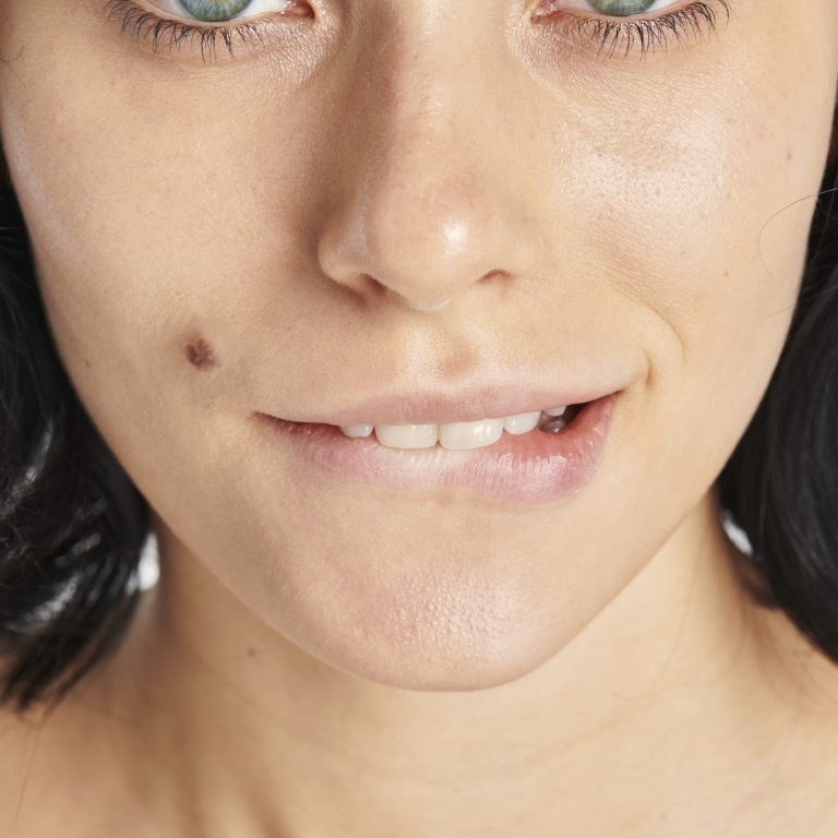 Blue eyed woman biting her lip