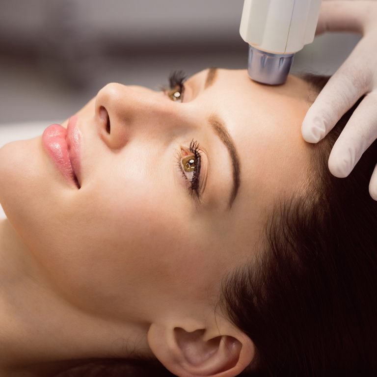 Female patient receiving cosmetic treatment at clinic